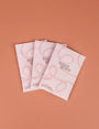 Three 'sweet grace' product packages on a brown background