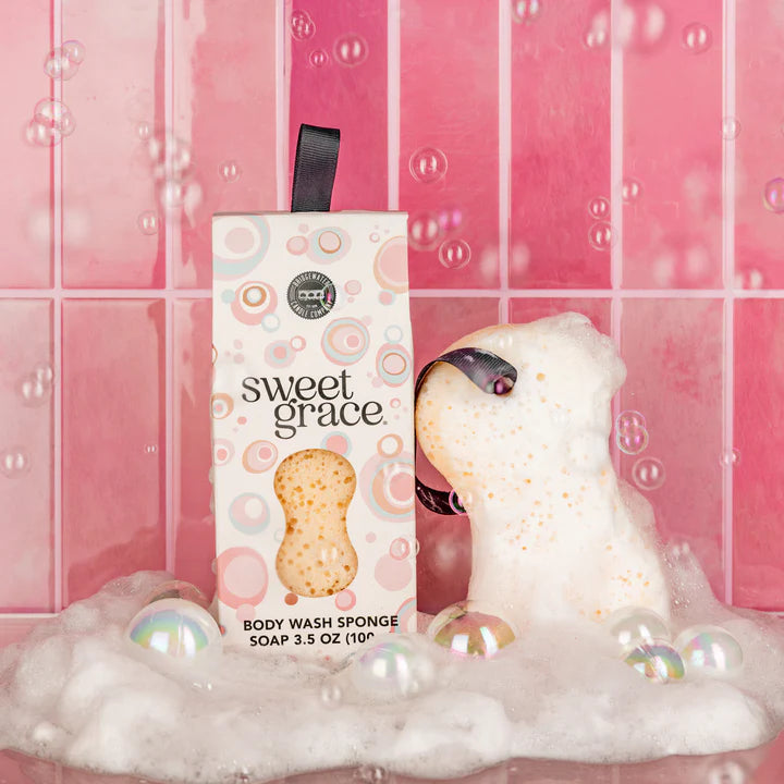 Body wash sponge with packaging labeled 'sweet grace' in a foamy bath setting.