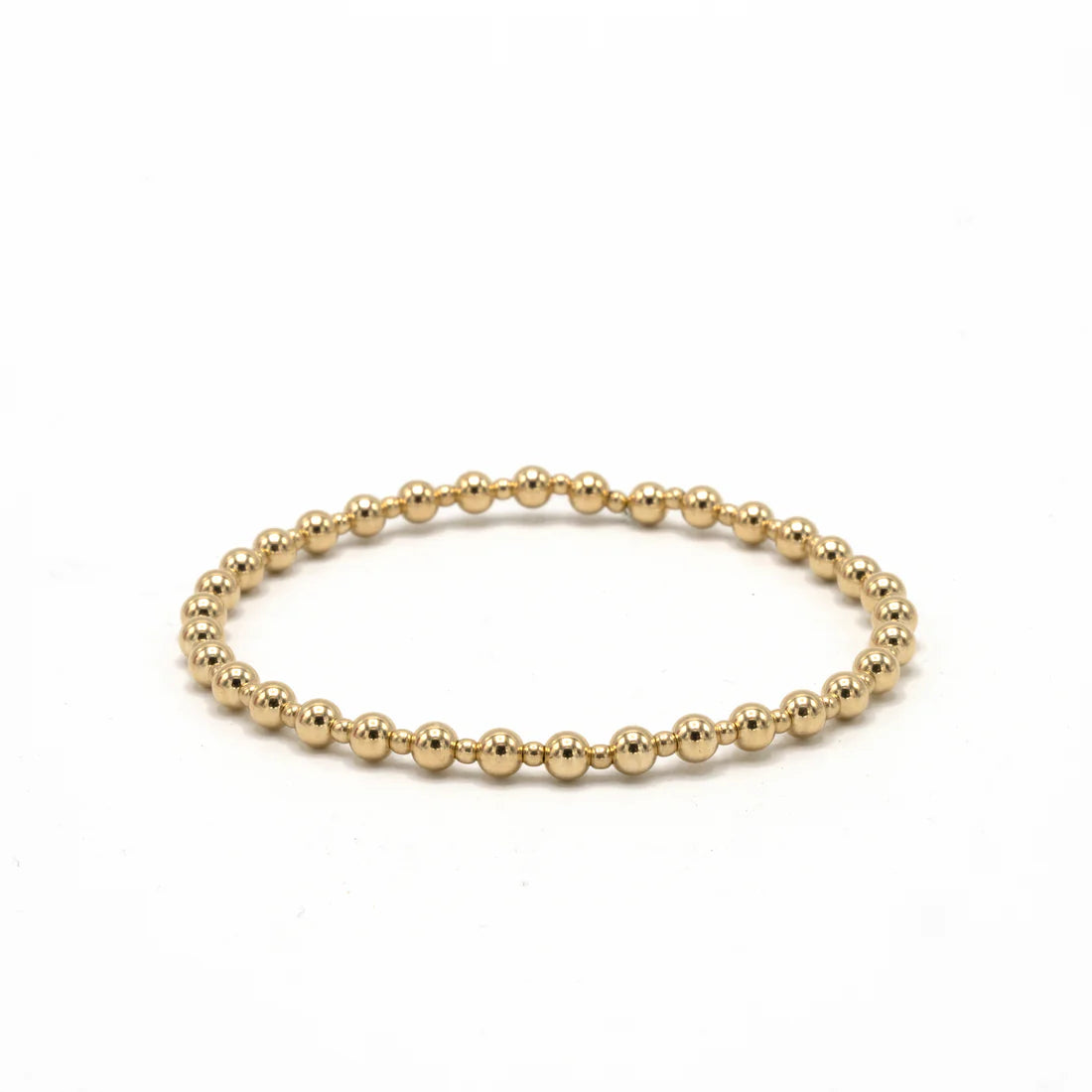 Gold beaded bracelet on a white background