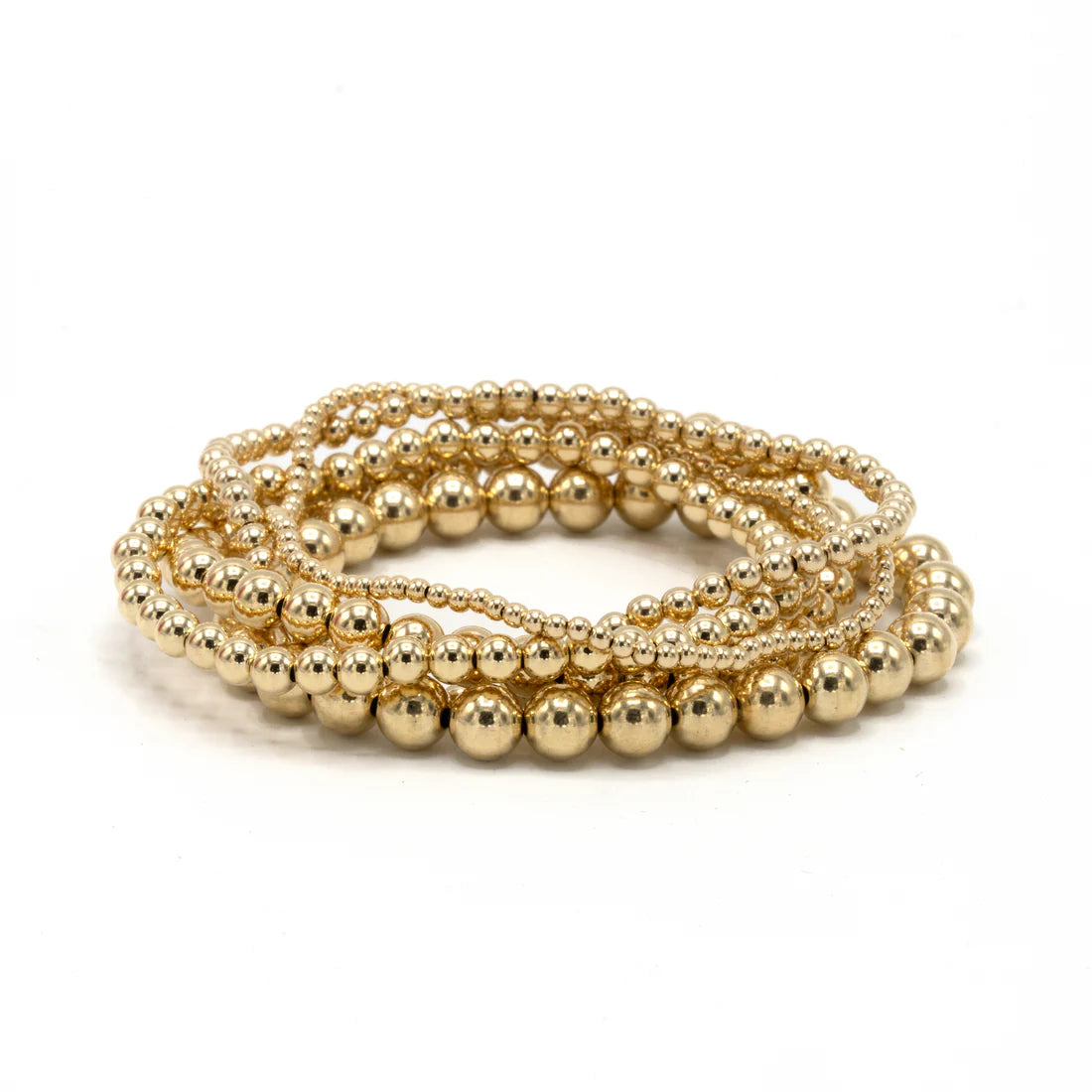 Gold beaded bracelet on a white background
