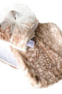 Beige sherpa blanket with a white shoe on a white background