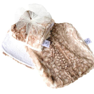 Beige sherpa blanket with a white shoe on a white background