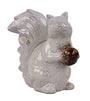 White ceramic squirrel figurine with a brown nut on a white background