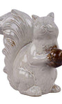 White ceramic squirrel figurine with a brown nut on a white background