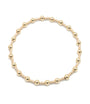 Gold beaded bracelet on a white background