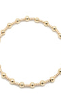 Gold beaded bracelet on a white background