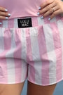 Pink and white striped shorts with 'LULU MAC' label, worn by a person.
