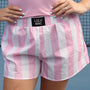 Pink and white striped shorts with 'LULU MAC' label, worn by a person.