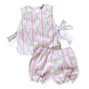 Baby outfit with checkered romper and white shirt on a plain background