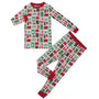 A two-piece children's pajama set featuring a festive holiday print of red and green Christmas stockings and ornaments on a white background, with red trim.