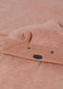Close-up of a pink fabric with a bear face design.