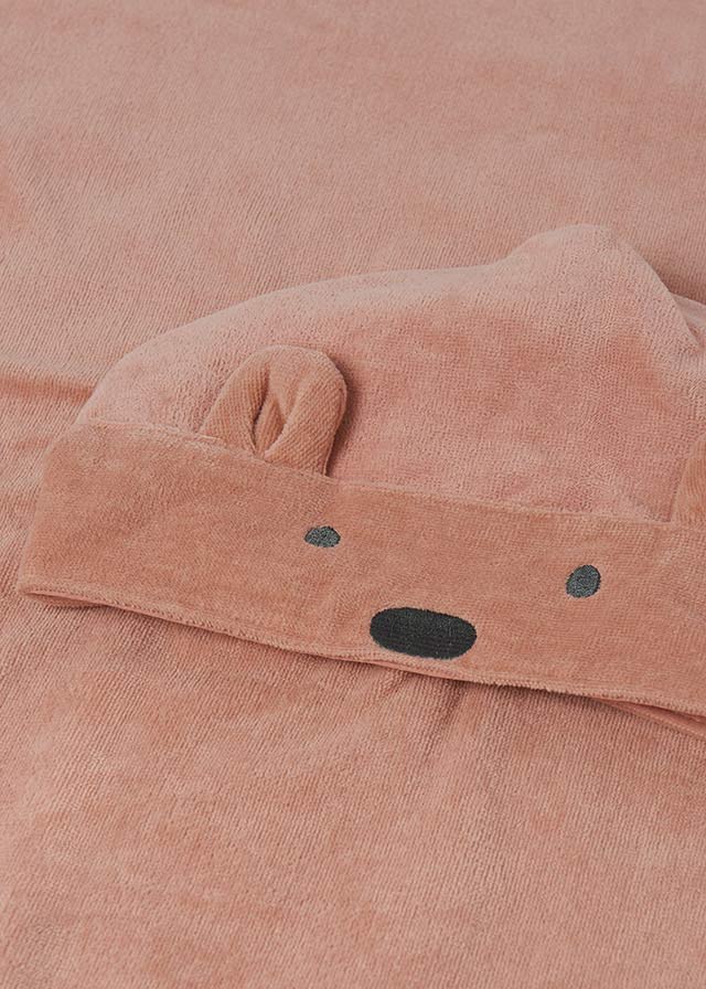 Close-up of a pink fabric with a bear face design.