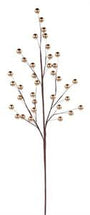 A decorative artificial branch with thin brown stems and small metallic gold berries, shown against a plain white background.
