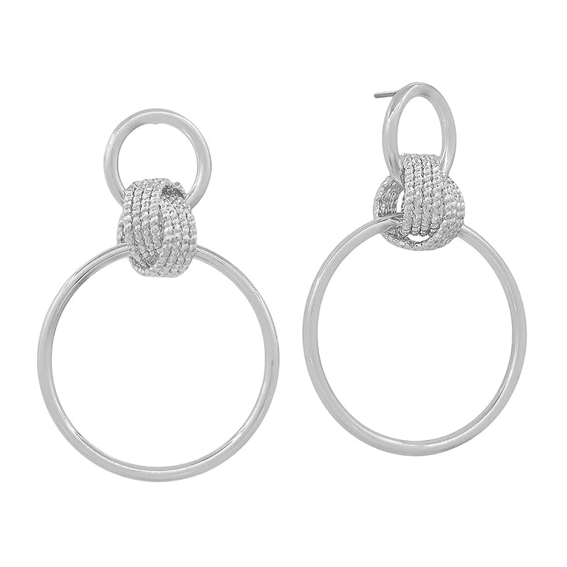A pair of silver-toned drop earrings featuring a textured, knotted circular top with a large, open circular drop below, shown on a plain white background.