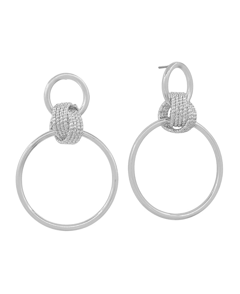 A pair of silver-toned drop earrings featuring a textured, knotted circular top with a large, open circular drop below, shown on a plain white background.