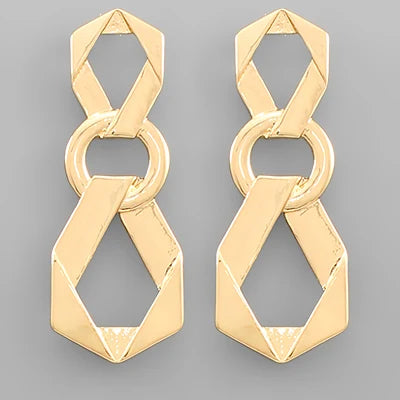 A pair of gold geometric drop earrings with interlocking circular and angular links, displayed on a neutral gray background.