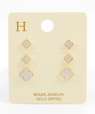 Set of gold-dipped earrings on a branded card with 'H' logo.