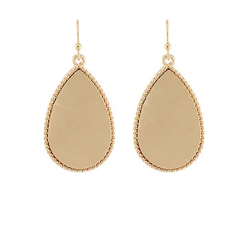 A pair of gold teardrop dangle earrings with a textured beaded border and a smooth, polished center, shown against a plain white background.