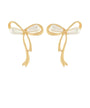 A pair of gold bow-shaped earrings with white pearl-like bead accents at the center, shown on a plain white background.