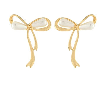 A pair of gold bow-shaped earrings with white pearl-like bead accents at the center, shown on a plain white background.
