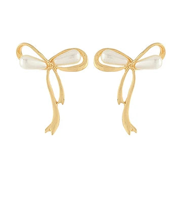 A pair of gold bow-shaped earrings with white pearl-like bead accents at the center, shown on a plain white background.