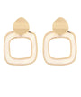 A pair of gold-toned geometric drop earrings with a rounded square frame and a teardrop-shaped top, shown on a plain white background.