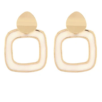 A pair of gold-toned geometric drop earrings with a rounded square frame and a teardrop-shaped top, shown on a plain white background.