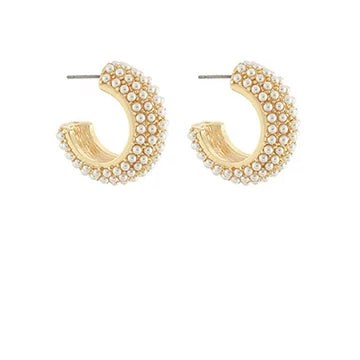 Gold hoop earrings with pearl-like beads on a white background