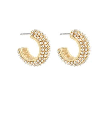 Gold hoop earrings with pearl-like beads on a white background