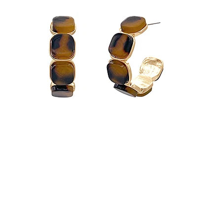 Pair of earrings with tortoiseshell design on a white background