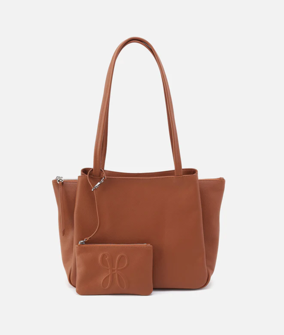 Brown leather handbag with matching pouch on a white background