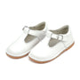 Pair of white children's shoes with buckles on a white background