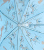A light blue umbrella viewed from underneath, featuring a repeating pattern of Dalmatian dogs in orange spots and blue collars on a pale blue background.