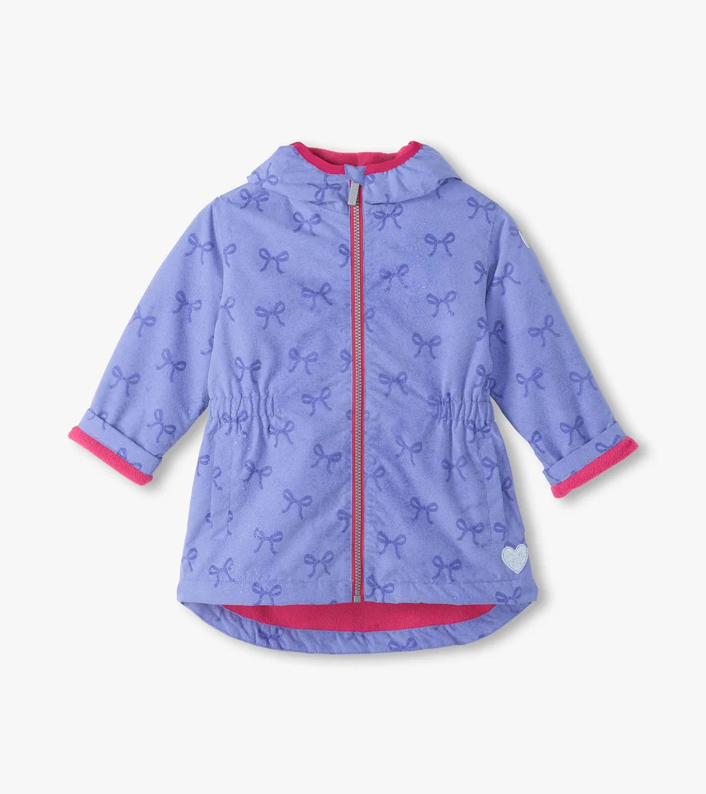 Purple children's jacket with bow pattern on a white background