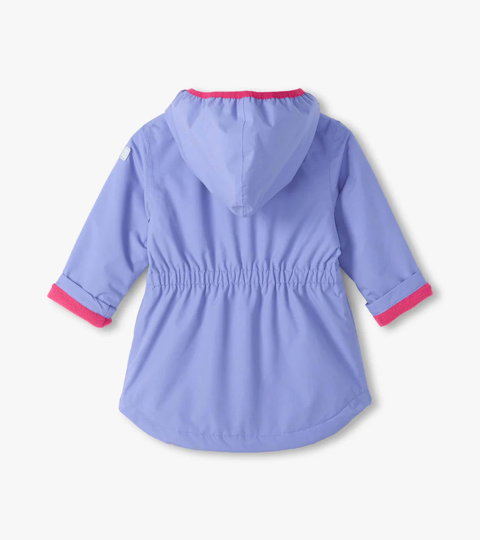 A light purple hooded raincoat shown from the back, featuring a drawstring waist and bright pink trim on the hood and cuffs, set against a plain off-white background.