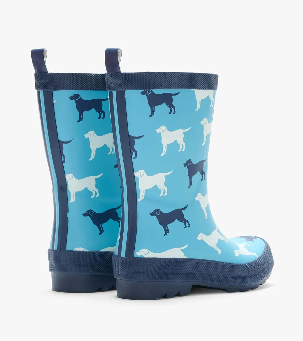 Navy rain boots with dog pattern on a blue background