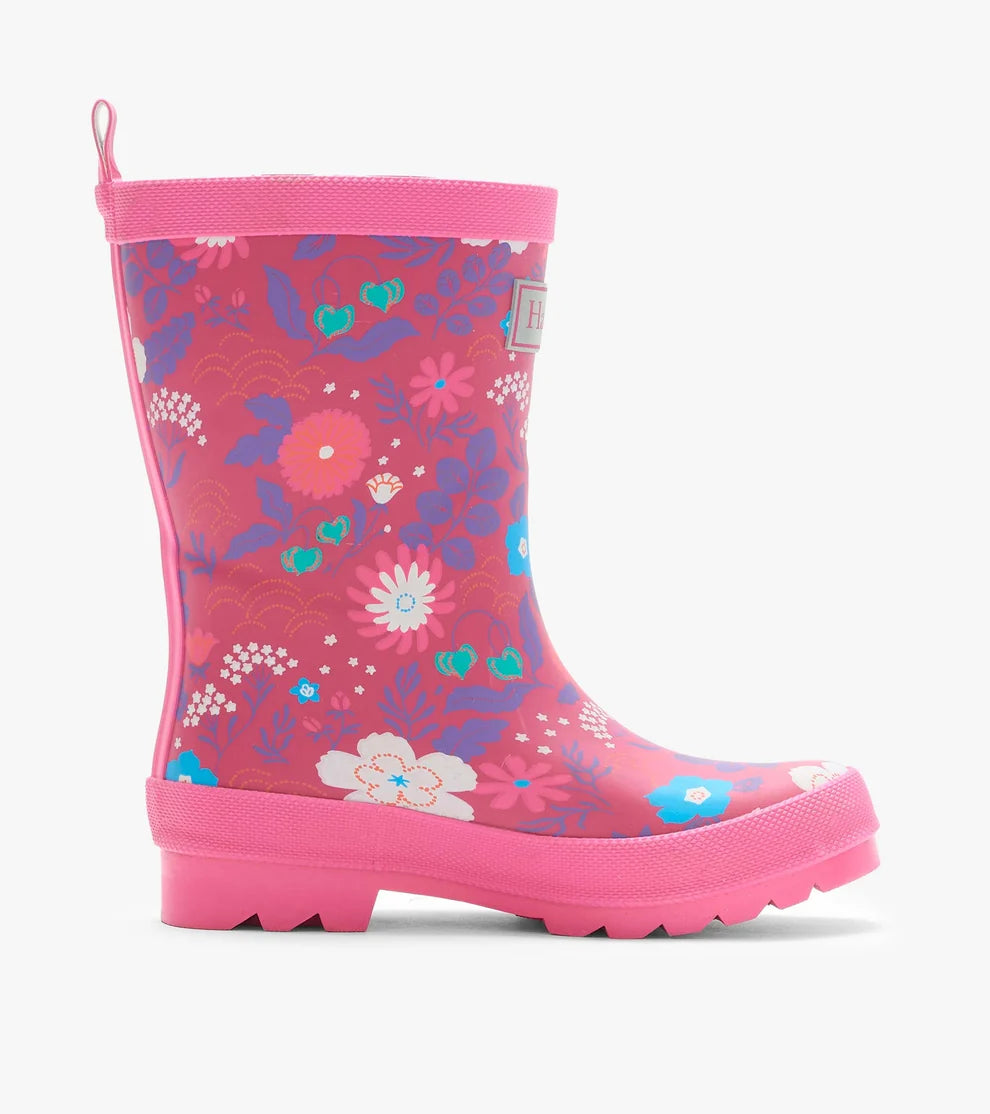 Pink children's rain boot with floral pattern on a white background