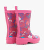 A pair of children's rain boots in vibrant pink, featuring a colorful floral and wave pattern on the upper and a solid pink sole and pull tabs, shown against a plain white background.
