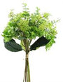 Bouquet of green artificial flowers in a clear vase