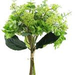 Bouquet of green artificial flowers in a clear vase