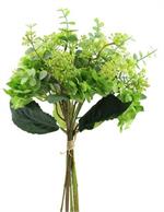 Bouquet of green artificial flowers in a clear vase