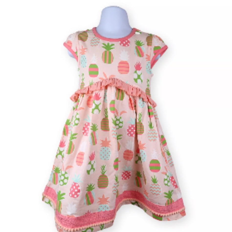 Children's dress with pineapple pattern on a white background