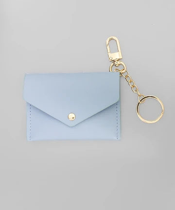 A light blue envelope-style card holder or coin purse with a gold snap button, attached to a gold keychain clasp and split ring, shown on a plain light gray background.