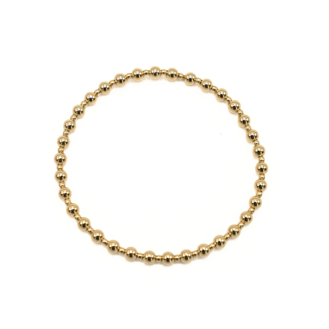Gold beaded bracelet on a white background