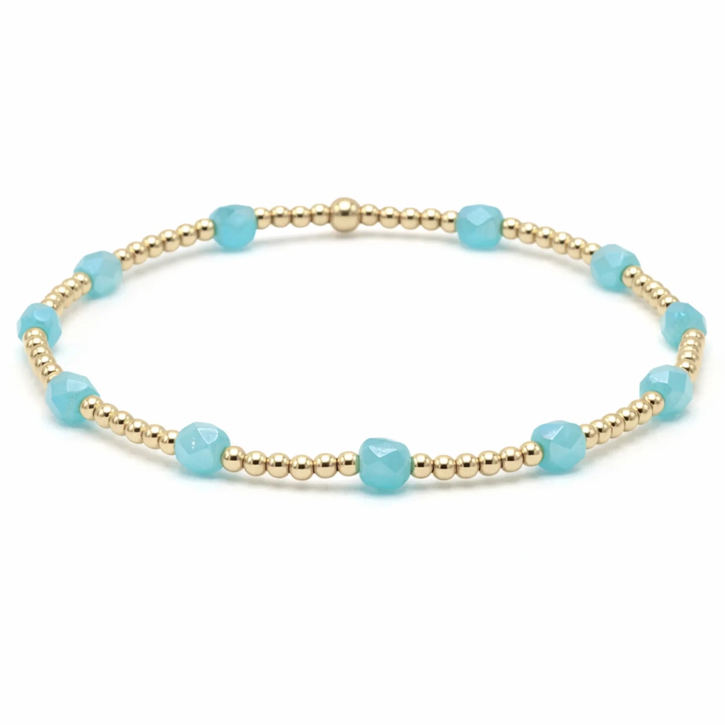 Bracelet with gold beads and turquoise stones on a white background