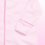 Close-up of a light pink garment, likely a jacket or coat, showing the sleeve cuff with a contrasting darker pink stripe and a matching pink zipper running down the front.