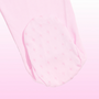 A close-up of a baby tights leg with a soft pink foot cap featuring a repeating bow pattern, set against a matching light pink gradient background.