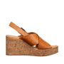 Brown wedge sandal with cork sole on a white background
