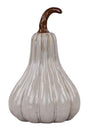 A decorative ceramic pumpkin with a glossy off-white glaze and vertical ribbing, featuring a curved brown stem, isolated on a white background.