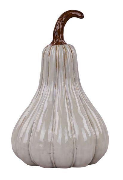 A decorative ceramic pumpkin with a glossy off-white glaze and vertical ribbing, featuring a curved brown stem, isolated on a white background.
